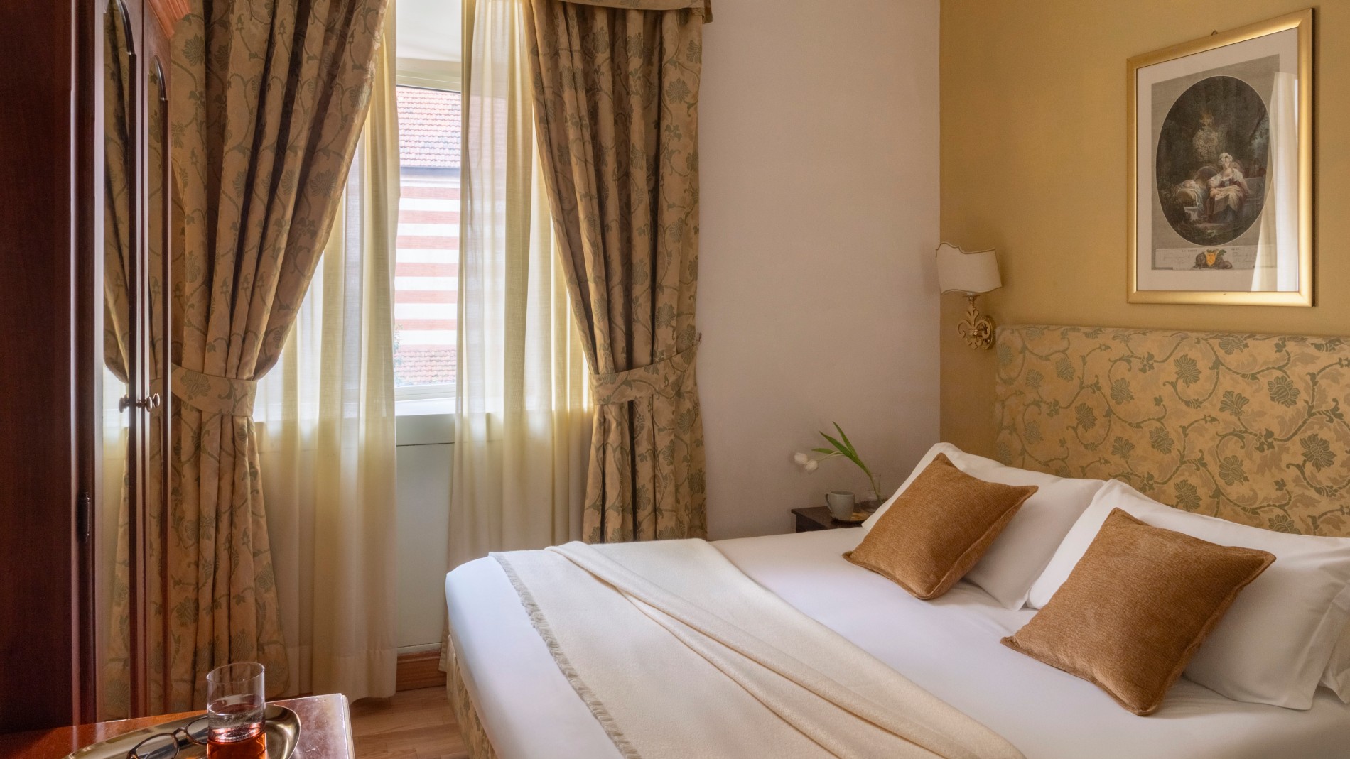 Interior of a superior room at Hotel Cortina featuring a double bed and classic Roman style. - Hotel Cortina, BZAR hotels in Rome